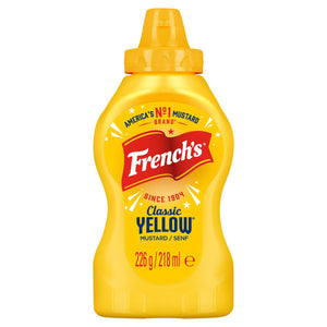 A bottle of French S American Classic Yellow Squeezy Mustard 226G Imported From Britain featuring the iconic red flag logo and a bright yellow squeeze bottle design.