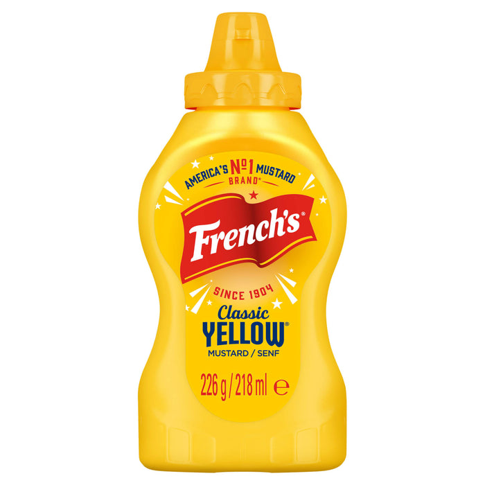 A bottle of French S American Classic Yellow Squeezy Mustard 226G Imported From Britain featuring the iconic red flag logo and a bright yellow squeeze bottle design.