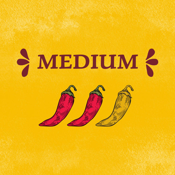 An illustration indicating a medium heat level for Cholula Original Mexican Hot Sauce 150Ml featuring two red chili peppers and one yellow chili pepper against a textured yellow background.