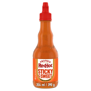 A bottle of Frank'S Squeeze Sticky Sweet 354 Ml hot sauce featuring a red squeeze cap and a vibrant orange label with a mild heat rating.
