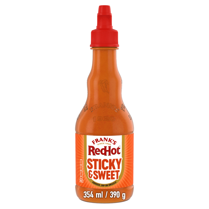 A bottle of Frank'S Squeeze Sticky Sweet 354 Ml hot sauce featuring a red squeeze cap and a vibrant orange label with a mild heat rating.
