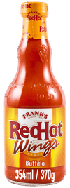 A glass bottle of Frank's RedHot Wings Buffalo Sauce, which is the product Franks Rdhot Bws Gb 24/148 Ml, is shown with its yellow and red label against a black background.