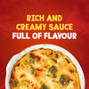 A close-up of a golden-brown broccoli and cauliflower cheese bake, a serving suggestion for Schwartz Cheddar Cheese Sauce 38G, is shown with the text Rich and Creamy Sauce Full of Flavour.