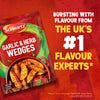 An advertisement for Schwartz Garlic And Herb Wedges, 38G, shows the product packet next to a bowl of seasoned potato wedges, with text proclaiming Schwartz as the UKs number one flavour experts.