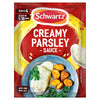 A red sachet of Schwartz Creamy Parsley Sauce 26G is shown next to a serving suggestion of the finished sauce poured over white fish with roasted potatoes and broccoli.