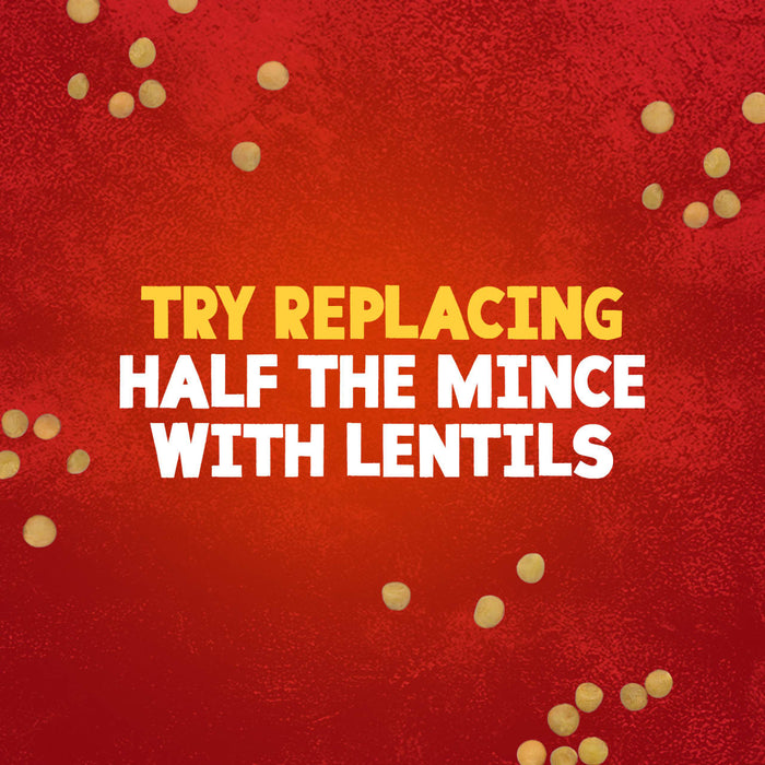 A graphic illustration with a red textured background and scattered lentils provides a cooking tip for Sa Cottage Pie, suggesting to try replacing half the mince with lentils.