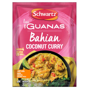 A pink sachet of Schwartz Las Iguanas Bahian Coconut Curry 25G is displayed in front of a black bowl filled with the prepared yellow curry, which contains chicken pieces and is garnished with a lime wedge.