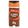 A clear glass Schwartz Ground Cloves 35G Jar filled with finely milled dark brown spice and topped with a signature orange and black flip-top lid.