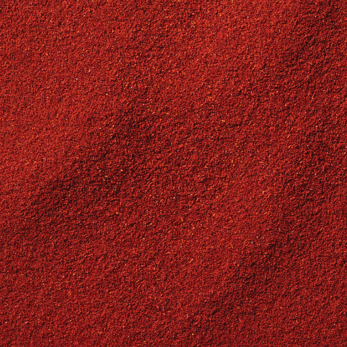 A close-up, top-down view shows the rich, red, and fine texture of Schwartz Smoked Paprika 40G.