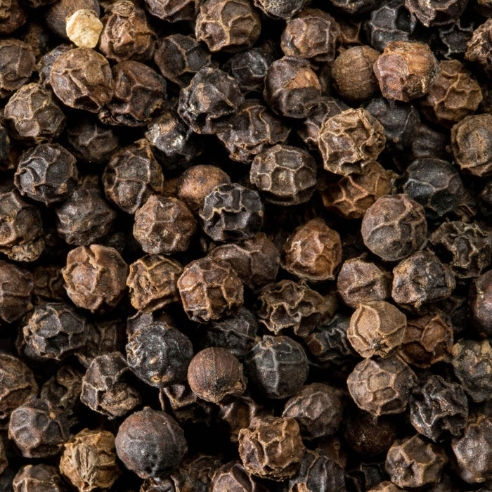 A detailed close up view of the whole dried berries that fill a Schwartz Black Peppercorns Adjustable Medium Grinder 35G.