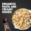 A bottle of Schwartz Black Peppercorns Adjustable Medium Grinder 35G is displayed next to a skillet of creamy pasta with bacon and mushrooms to show how it enhances pasta and creamy dishes.