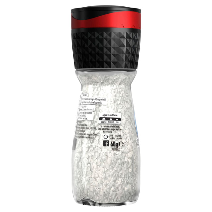 A clear glass grinder bottle of Schwartz Sea Salt, 60G showing the coarse white salt crystals and the adjustable black and red grinder cap.