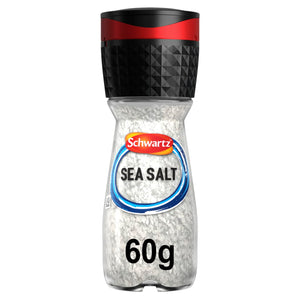 A clear glass grinder bottle of Schwartz Sea Salt, 60G shows the coarse white salt crystals through the label and features a black and red adjustable grinding cap.