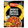 A packet of Schwartz Smoked Paprika Chicken 28G seasoning mix featuring a vibrant yellow brushstroke design and a bowl of the prepared dish with chicken and chorizo.