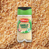A clear jar of Schwartz Garlic Granules 50G is shown against a background of the same spice.