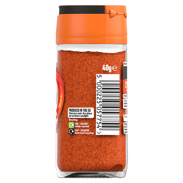 The back of a glass jar of Schwartz Paprika 40G displays the barcode, recycling symbols, and storage instructions against a black background.