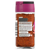 The back label of a glass jar of Schwartz Harissa 48G displays a blend of crushed chillies, paprika, and caraway along with a full list of ingredients and serving suggestions.