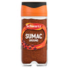 A clear glass jar of Schwartz Sumac Ground 44G featuring a vibrant orange cap and a label showing the deep red spice and whole sumac berries.