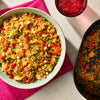 A vibrant bowl of fried rice seasoned with Schwartz Af Chinese Cs Sea and mixed with colorful peas, red peppers, and scrambled eggs.