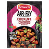 A Schwartz sachet of Sa Af Chorizo Chicken recipe mix is shown in front of a black bowl containing the finished dish of cooked chicken, chorizo, and vegetables.