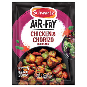 A Schwartz sachet of Sa Af Chorizo Chicken recipe mix is shown in front of a black bowl containing the finished dish of cooked chicken, chorizo, and vegetables.