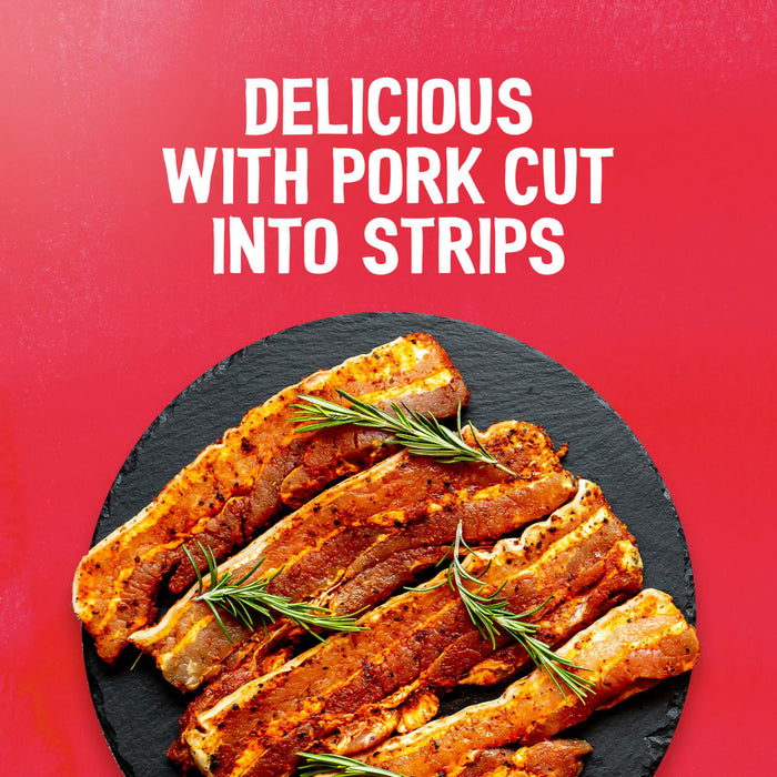 Seasoned raw pork strips garnished with rosemary on a black slate platter show a delicious use for the Sa Rt Chicken Satay X12, with the text Delicious with pork cut into strips on a red background.
