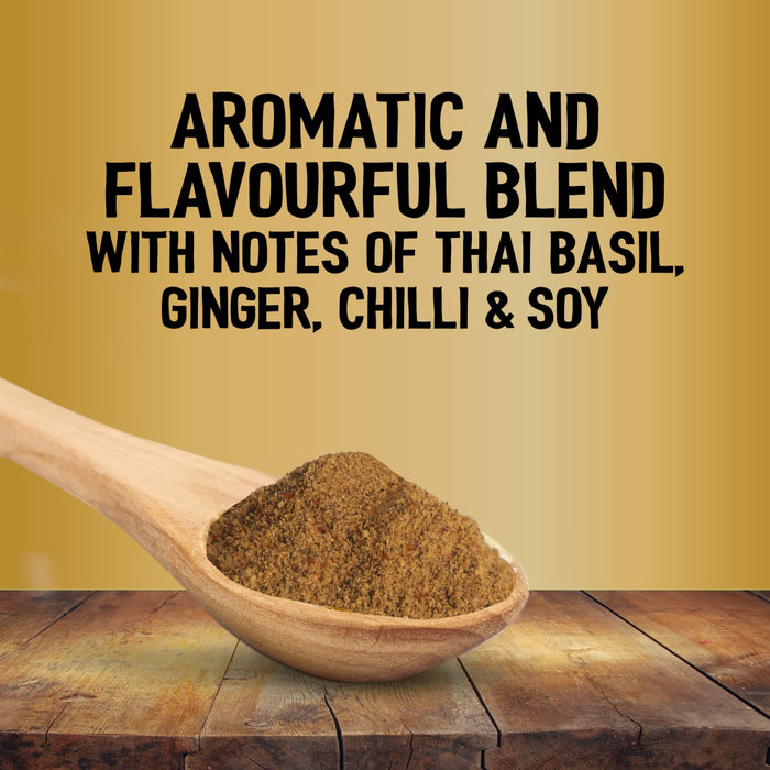 A wooden spoon holds a mound of Jr Thai Sweet Chil Seas X6 seasoning over a rustic wooden table against a gold background with text describing the aromatic blend of Thai basil, ginger, chilli, and soy.