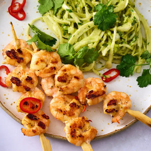 Grilled shrimp skewers seasoned with Jr Lemon Pepper Seas X6 are served alongside a fresh green slaw and garnished with cilantro and red chili slices.