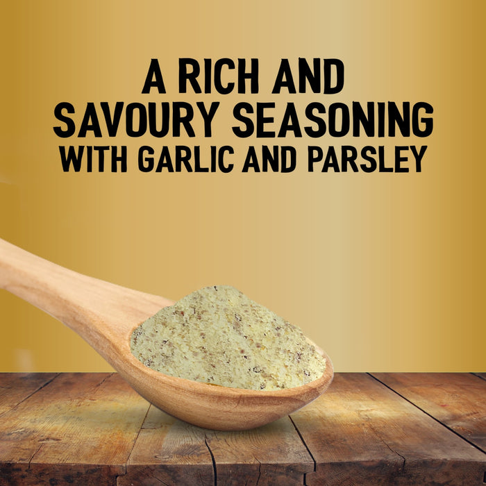 A wooden spoon holds a heap of Jr Garlic Butter Seas X6 over a rustic wooden table against a gold background with text describing it as a rich and savoury seasoning with garlic and parsley.