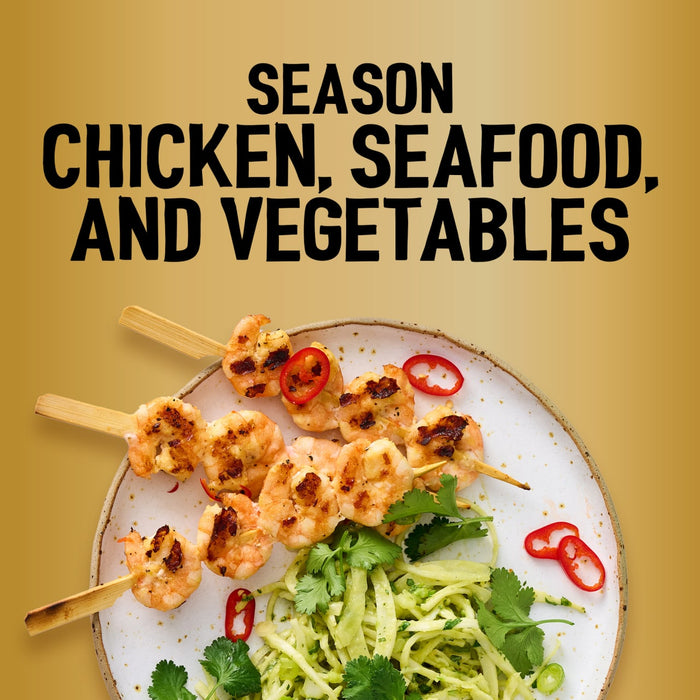 Grilled shrimp skewers seasoned with Jr Garlic Butter Seas X6 are served over a bed of zesty slaw with fresh cilantro and sliced red chilies on a speckled plate.
