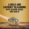 A wooden spoon filled with Jr Every Bagel Seas X6 rests on a rustic table against a gold background with text describing it as a bold and savoury seasoning with sesame seeds and garlic.