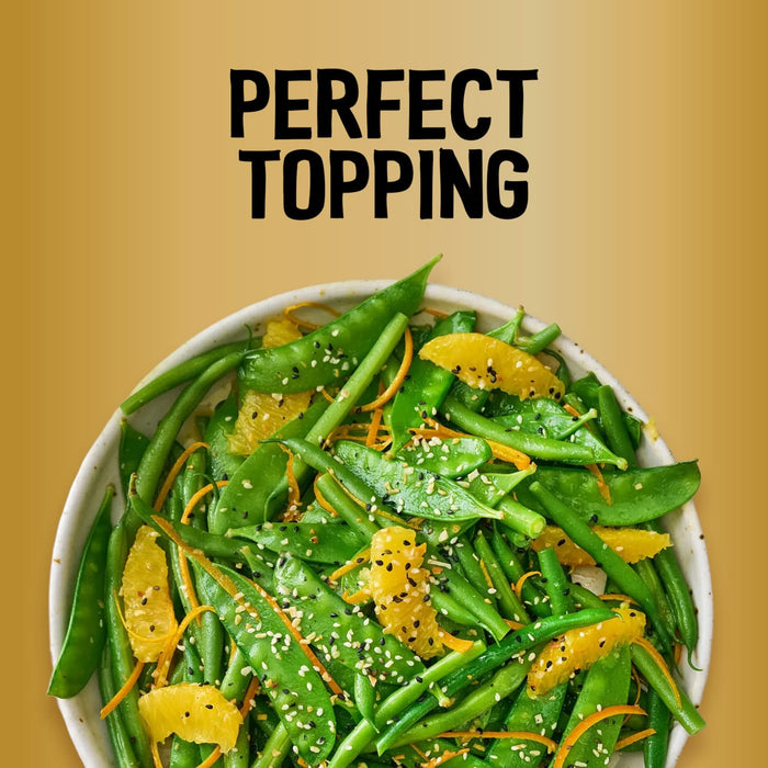 A vibrant salad of green beans and snap peas garnished with orange segments and a generous sprinkle of Jr Every Bagel Seas X6 under the text Perfect Topping.