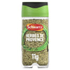 A clear glass jar of Schwartz Herbes De Provence, 11G featuring a green lid and a label showing a blend of dried herbs.