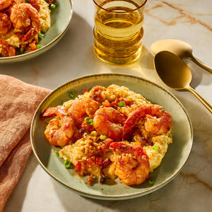 A plate of savory shrimp and grits is seasoned with Schwartz Paprika Hot, 34G to add a bold and spicy kick to the dish.