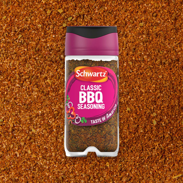 A jar of Schwartz Classic Bbq Seasoning 44G is centered against a background of the loose reddish brown spice blend.