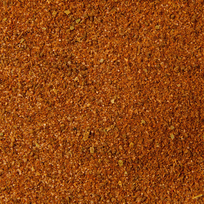 A close up view shows the fine texture and rich reddish brown color of Schwartz Classic Bbq Seasoning 44G.