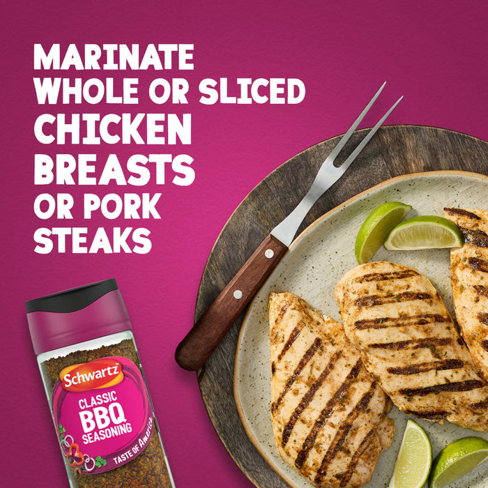 A bottle of Schwartz Classic Bbq Seasoning 44G is displayed next to a plate of grilled chicken breasts and lime wedges to show how it can be used to marinate whole or sliced chicken breasts or pork steaks.