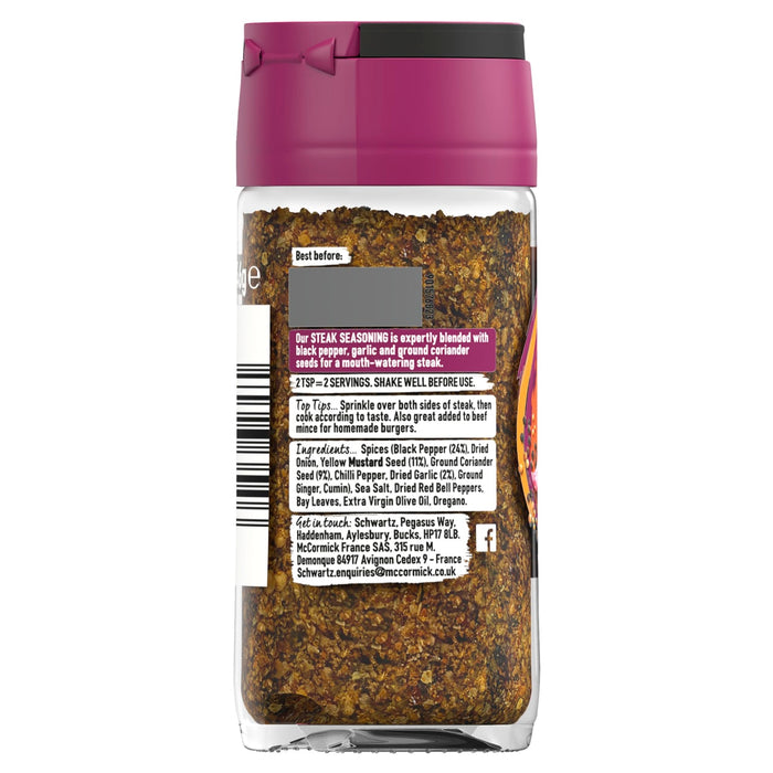 The back of a glass jar of Schwartz Pepper & Garlic Steak Seasoning 46G displays the coarse blend of spices and the product label with ingredients and usage tips.