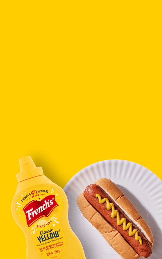 Frenchie mustard bottle and a hot dog with mustard on a yellow background