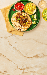 Tortillas with toppings on a green plate on a marble surface