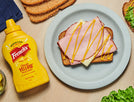 French's mustard bottle and ham sandwich