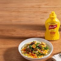 french's classic yellow mustard next to a bowl of soup