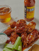 Old Bay hot sauce chicken wings with celery and honey dip