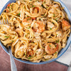 A delicious bowl of fettuccine with shrimp and crab is shown, a perfect recipe to create with a seasoning from a Barrel.